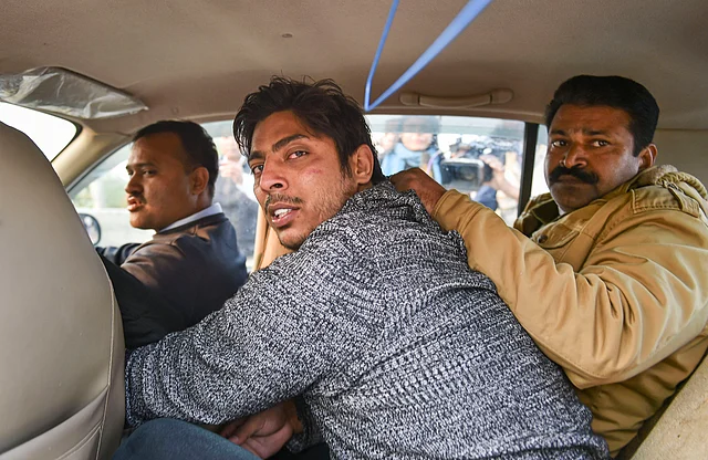 Police take away a person after he allegedly opened fire in the Shaheen Bagh area of New Delhi, Saturday, 1 February 2020.