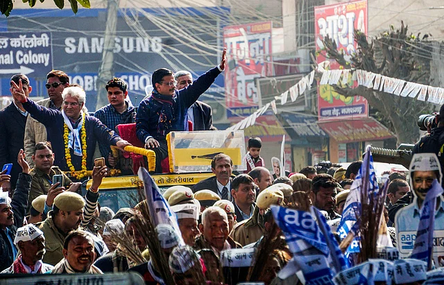 Delhi Chief Minister Arvind Kejriwal, during an election campaign roadshow in support of party candidate and Transport Minister Kailash Gahlot (L) in Najafgarh constituency, ahead of the Assembly elections, in New Delhi, Saturday, 1 February 2020.