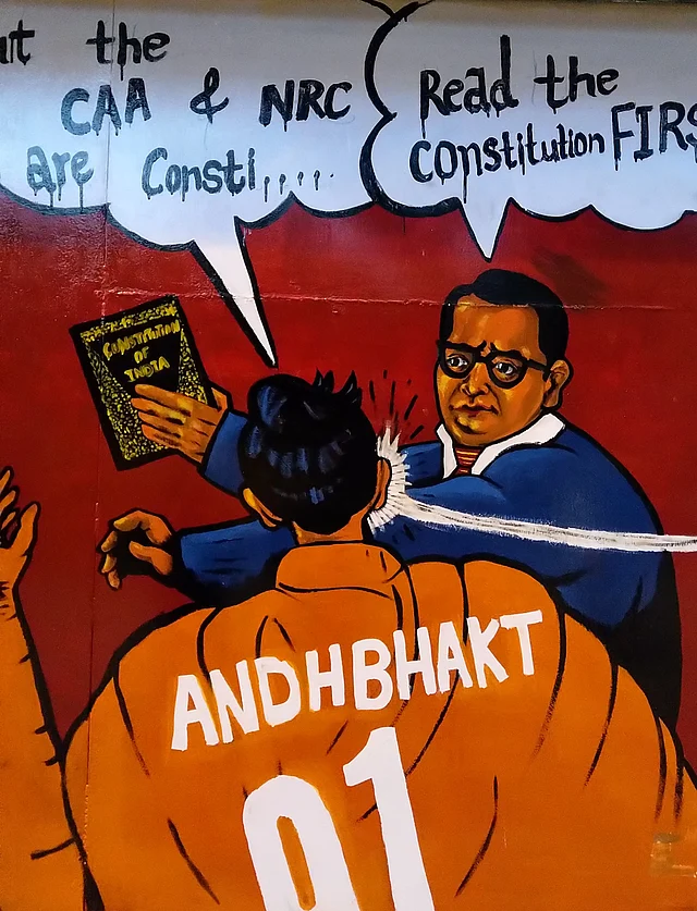 This artwork outside Jamia shows BR Ambedkar responding to the CAA with the Constitution.
