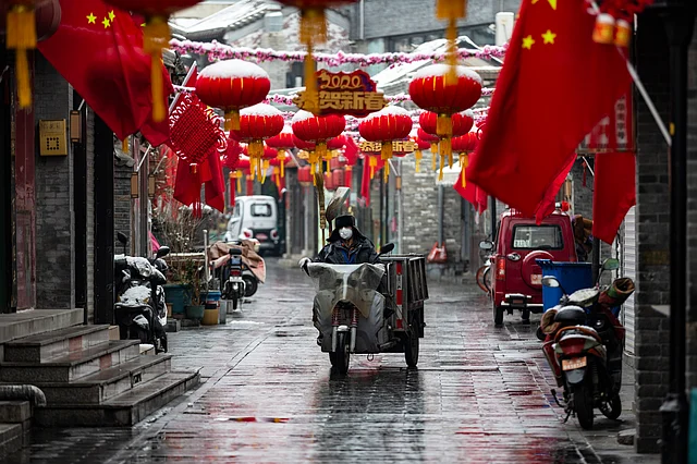 Red lanterns, national flags and other auspicious decorations are hung upon houses in a lane in Beijing. Local residents, who have rarely gone outdoors these days because of the outbreak of novel coronavirus, celebrate Chinese New Year.