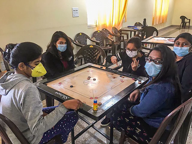 Indians evacuated from China amid the outbreak of the Coronavirus epidemic play carom at a quarantine facility set by up ITBP, at Chhawla area of New Delhi.