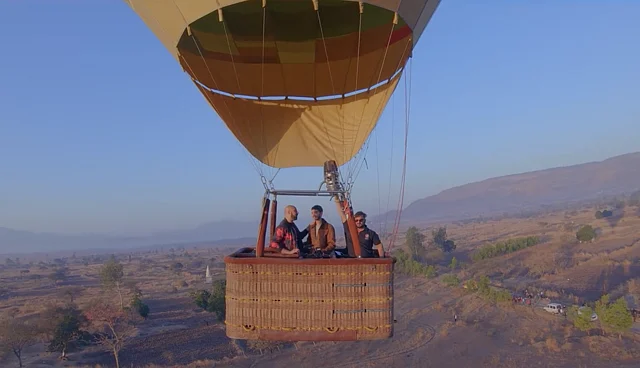 The contestant along with his date on the hot air balloon.