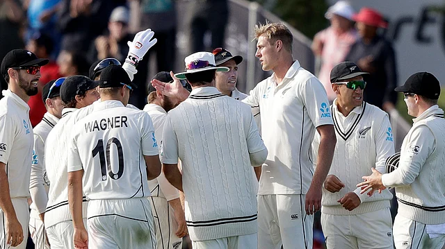 New Zealand’s Kyle Jamieson, third right, is congratulated by teammates after taking his fifth wicket that of India’s Ravindra Jadeja during play on day one of the second cricket test between New Zealand and India at Hagley Oval in Christchurch.