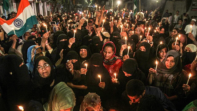 Muslim women take part in a candlelight protest against the Citizenship Amendment Act (CAA), at Nagpada, in Mumbai on Monday.