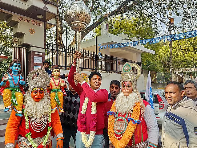AAP candidate from Greater Kailash constituency Saurabh Bhardwaj holds a mace as he along with his supporters, dressed as Lord Hanuman, celebrates his victory in the Assembly polls, outside a temple in New Delhi, Tuesday, 11 February 2020. 