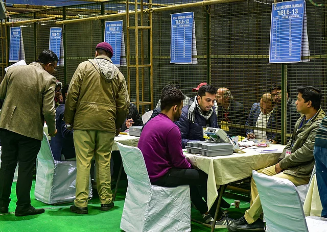 Election officials carry out counting of votes for Delhi Assembly poll at a counting centre in Akshardham.
