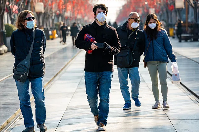 Foreign tourists walk along the Qianmen pedestrian street in Beijing.