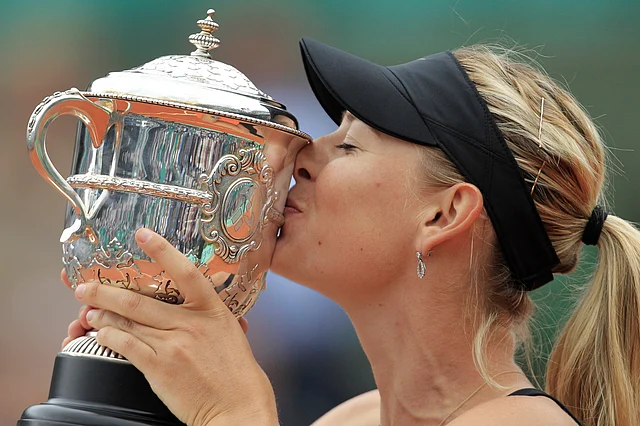 In this June 9, 2012, file photo, Maria Sharapova of Russia holds the trophy after winning the women’s final match against Sara Errani of Italy at the French Open tennis tournament at Roland Garros stadium in Paris. 