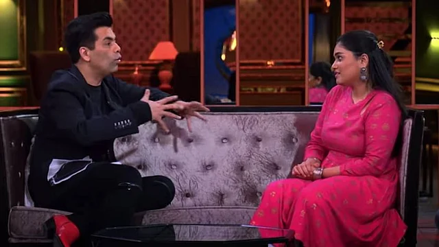 Karan Johar in conversation with a contestant.