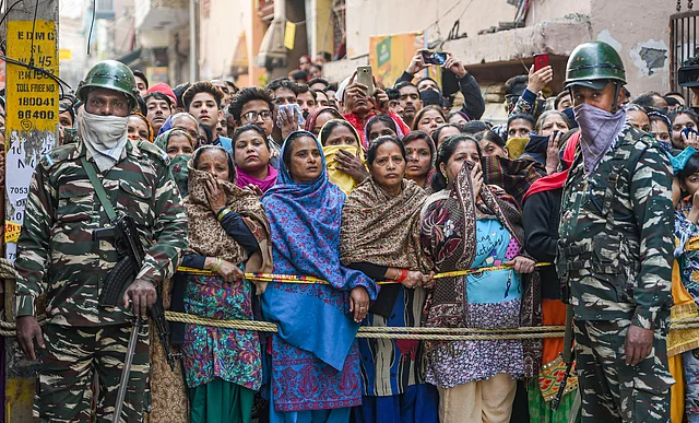 Locals outside a house where five members of a family were found dead at Bhajanpura area of New Delhi, on Wednesday.
