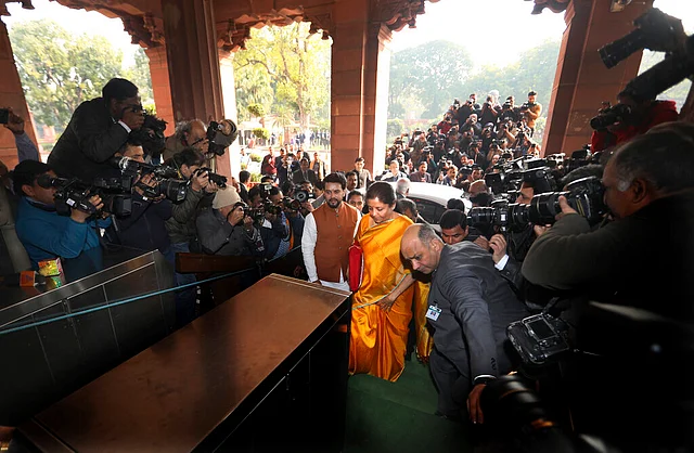 Finance Minister Nirmala Sitharaman and Minister of State Anurag Thakur arrive at the parliament house before presenting the federal budget in New Delhi, on Saturday, 1 February 2020.