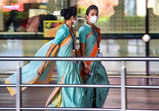 Fight employees are seen wearing protective masks as precautionary measure against the coronavirus, at the international airport in Mumbai, Thursday, 12 March 2020.