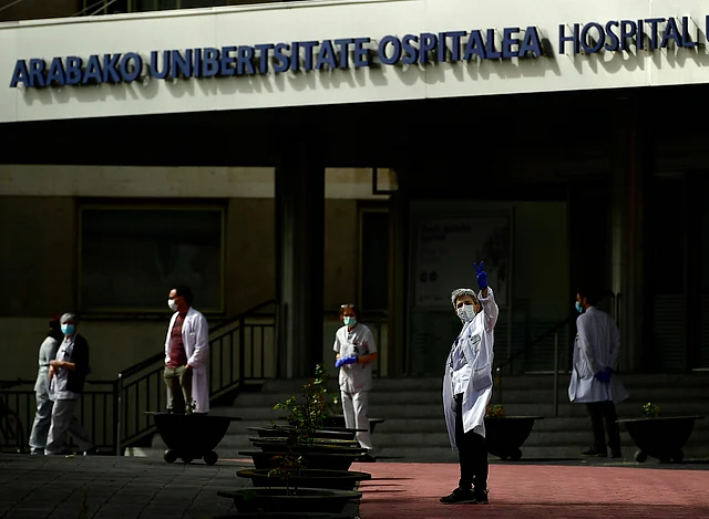 Health services staff members protest outside the Txagorritxu hospital demanding more protection equipment in a hospital, in Vitoria, northern Spain.