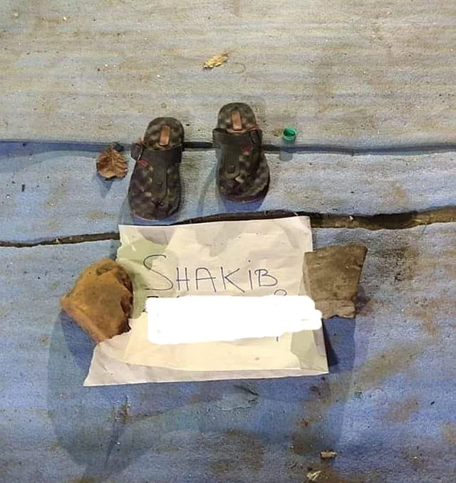 A protester leaves their shoes and a piece of paper with their name on it at the Park Circus protest venue.