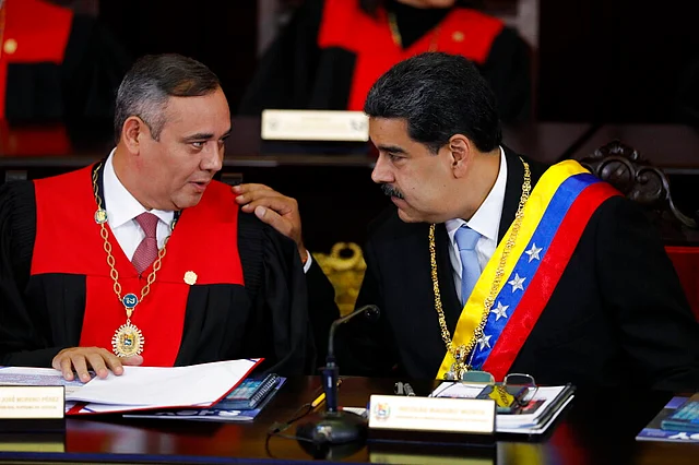 In this 31 Jan 2020 file photo, Venezuelan President Nicolas Maduro, right, speaks with Supreme Court President Maikel Moreno at the Supreme Court in Caracas, Venezuela. Maduro is at the court to give his annual presidential address.