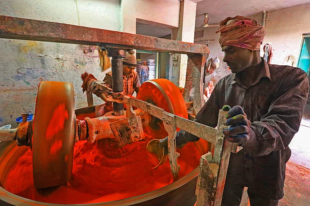 Workers prepare herbal gulal powder ahead of Holi festival, in Jaipur, Tuesday, 3 March, 2020.