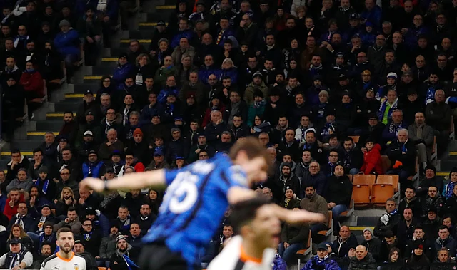 FILE - In this Wednesday, Feb. 19, 2020 file photo, spectators sit in the stands during the Champions League round of 16, first leg, soccer match between Atalanta and Valencia at the San Siro stadium in Milan, Italy.