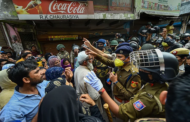 Police personnel talk to locals near Shaheen Bagh protest site.