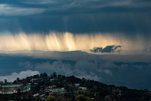 Streaks of rain and dark clouds are seen over the Kangra Valley in Dharmsala, India, Saturday, 29 February, 2020. The region saw heavy rains and thunderstorm on Saturday morning.