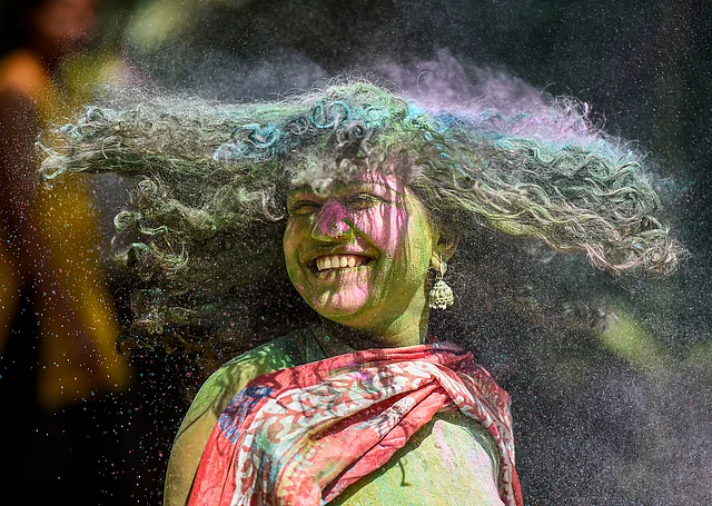 A reveller smeared in colour powder celebrates Holi, the spring festival of colours, in Mumbai, Tuesday, 10 March 2020.