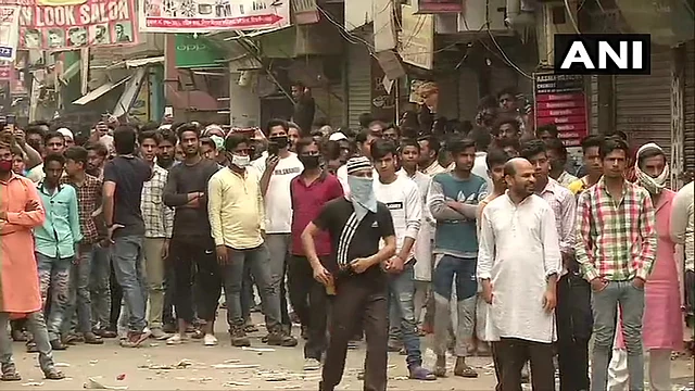 Locals gather after the police clears protest site.