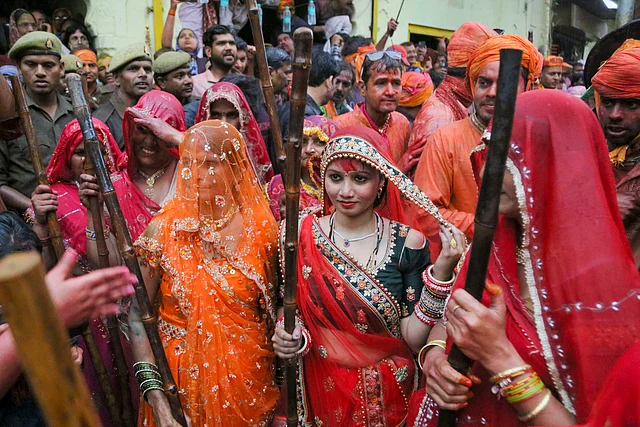 Women hold wooden sticks to beat men during the Lathmar Holi festival, in Barsana Wednesday, 4 March, 2020.