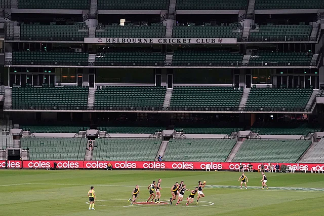 Players from Richmond and Carlton play their Australian Rules Football league game at a empty Melbourne Cricket Ground in Melbourne, Thursday, 19 March 2020.