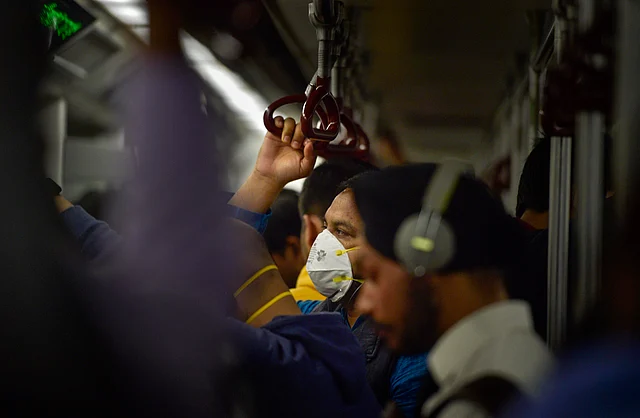 A commuter wears protective mask in wake of the deadly novel coronavirus, while travelling in a metro, in New Delhi, Wednesday, 4 March, 2020.
