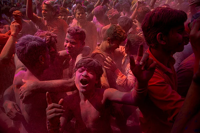 Indians dance and throw coloured powder during Holi festival celebrations in Gauhati, India, Tuesday, 10 March 2020. The festival heralds the arrival of spring.