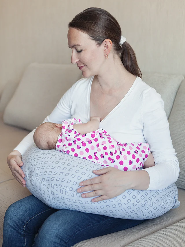 The pillow helps you prop your baby up while breastfeeding.