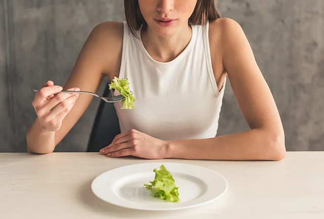 Denial and preoccupation with food and weight are the two most important signs of trouble.
