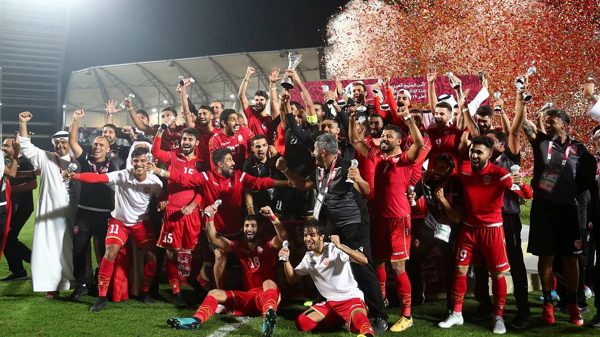 Bahrain players and coaching staff celebrate winning the Gulf Cup after the match.