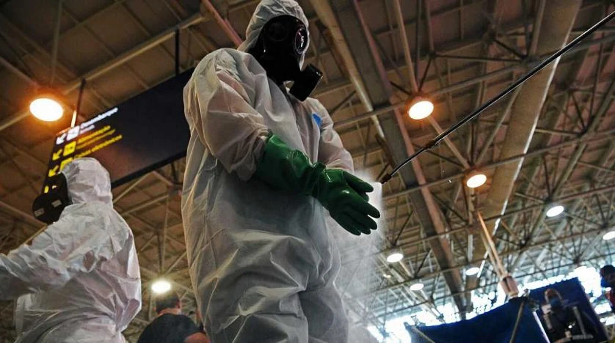 A soldier disinfects his gloves after carrying out a disinfection operation against COVID-19 at Tom Jobim Galeao International Airport in Rio de Janeiro, Brazil, on April 24, 2020. (AFP)