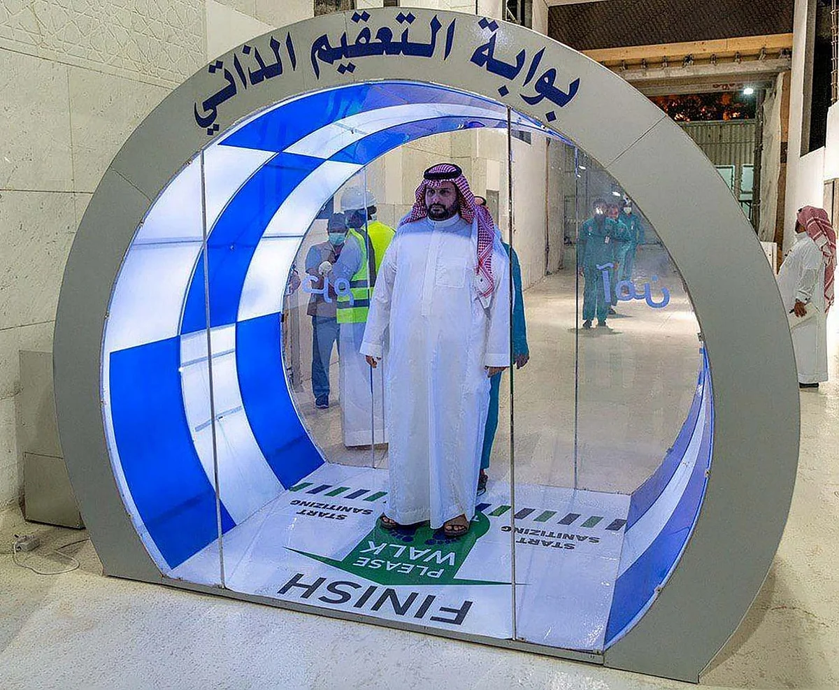 A Saudi man enters a new self-sterilization gate at the Grand Mosque, as a preventive measure against the COVID-19, during the holy month of Ramadan, in the holy city of Mecca, Saudi Arabia May 7, 2020.Saudi Arabia called on people to comply with health measures to prevent the spread of the coronavirus on Sunday, as its daily tally of cases rose above 4,000 for the first time. (REUTERS/Saudi Press Agency/Handout)