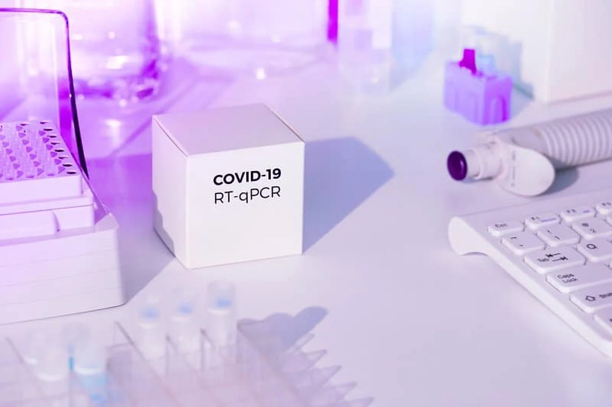 Test kit to detect novel COVID-19 coronavirus in patient samples. RT-PCR kit reagents convert viral Covid19 RNA to DNA and amplify region of viral DNA specific for 2019-nCov. Neon glow, purple light.