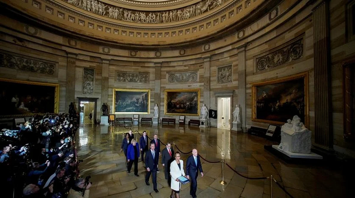 House Sergeant at Arms Paul Irving and House Clerk Cheryl Johnson carry two articles of impeachment against US President Trump during a procession through the US Capitol to the US Senate in Washington, US, Jan. 15, 2020. (Reuters)