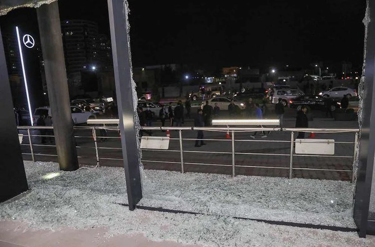 Shattered glass is pictured on the floor of a shop following a rocket attack in Irbil, the capital of the northern Iraqi Kurdish autonomous region, on Feb. 15, 2021. (AFP)