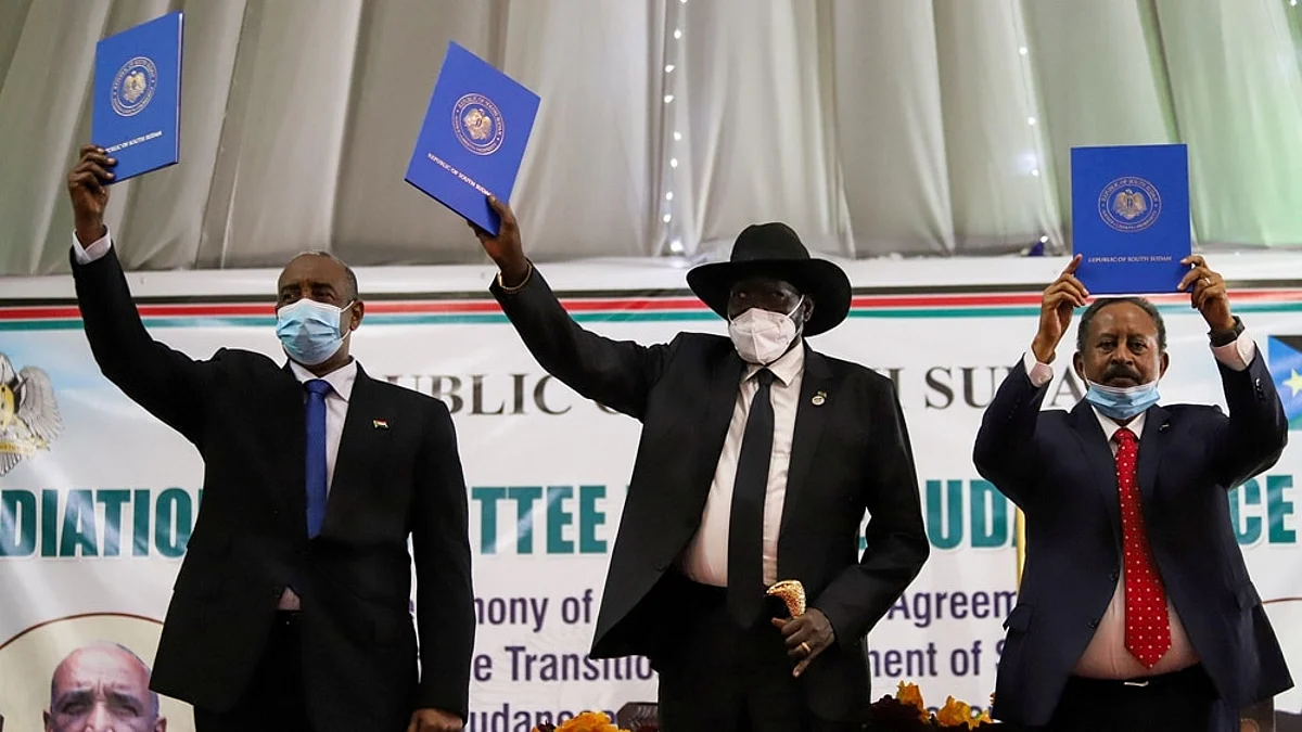 FILE PHOTO: Sudan's Sovereign Council Chief General Abdel Fattah al-Burhan, South Sudan's President Salva Kiir, and Sudan's Prime Minister Abdalla Hamdok lift copies of a signed peace agreement with the country's five key rebel groups, a significant step towards resolving deep-rooted conflicts that raged under former leader Omar al-Bashir, in Juba, South Sudan August 31, 2020. REUTERS/Samir Bol/File Photo