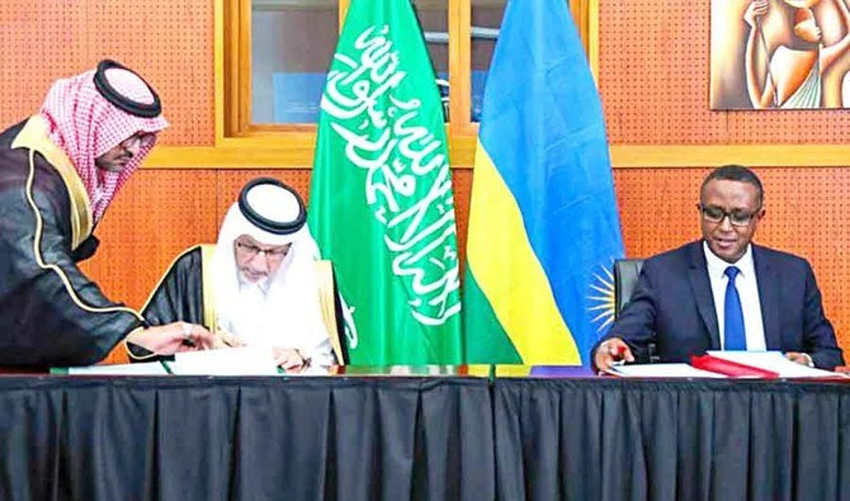 Minister of State for African Affairs Ahmed bin Abdul Aziz Kattan signs a deal with Rwanda’s Foreign Minister Vincent Perrotta. (SPA)