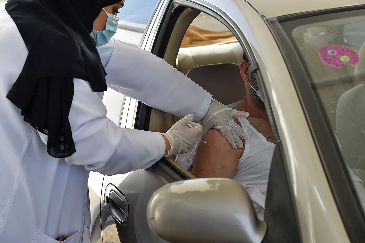 A medical worker administers a dose of the AstraZeneca COVID-19 vaccine at the first drive-through vaccination center in the Saudi capital Riyadh, on March 4, 2021. (Photo by Fayez Nureldine / AFP) (Photo by FAYEZ NURELDINE/AFP via Getty Images)