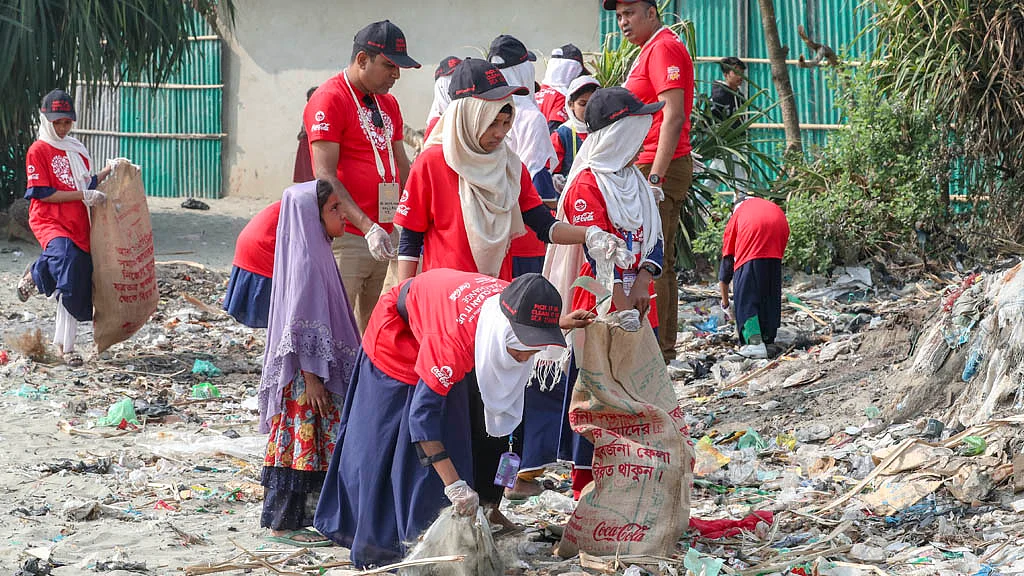 Local school students join volunteers in a cleanliness drive at St Martin's Island.