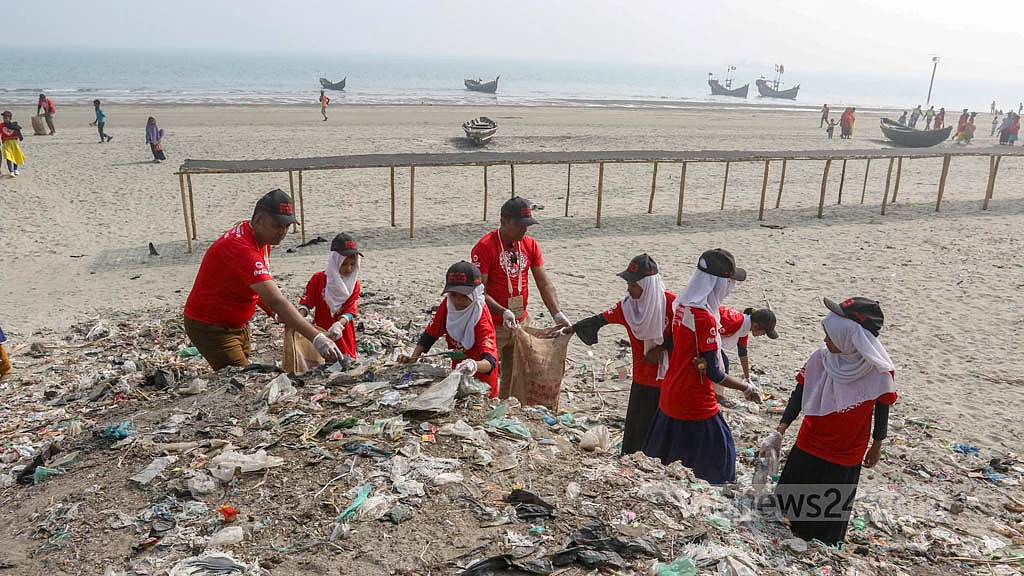 Local school students join volunteers in a clean-up drive as part of the International Coastal Cleanup campaign at St Martin's Island on Friday, Dec 16, 2022. 