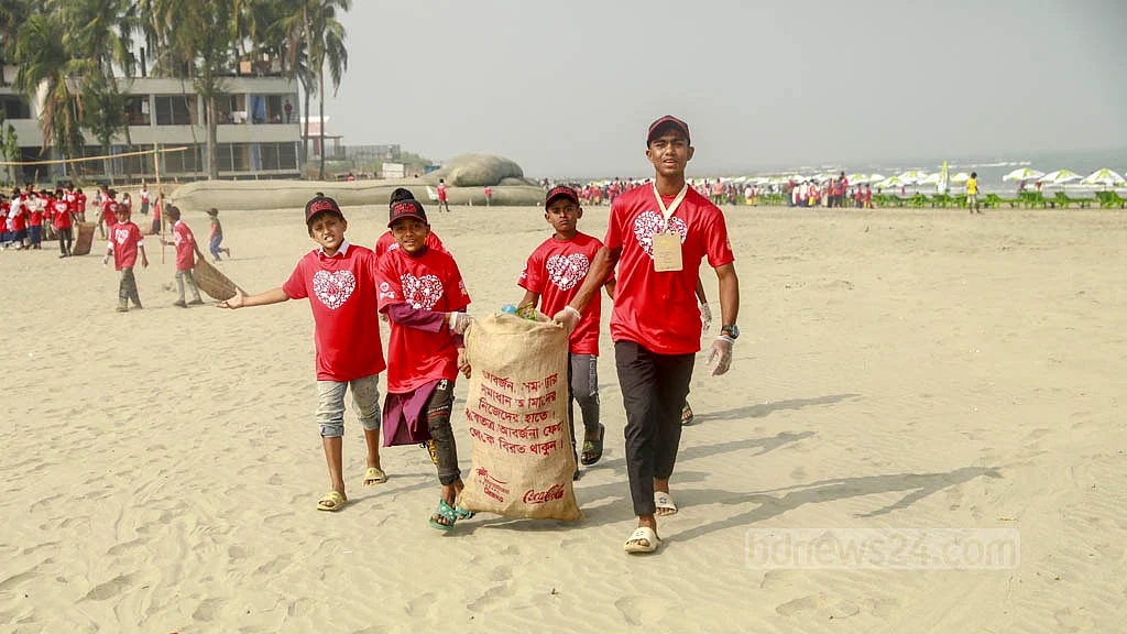 Local school students join volunteers in a clean-up drive as part of the International Coastal Cleanup campaign at St Martin's Island on Friday, Dec 16, 2022.