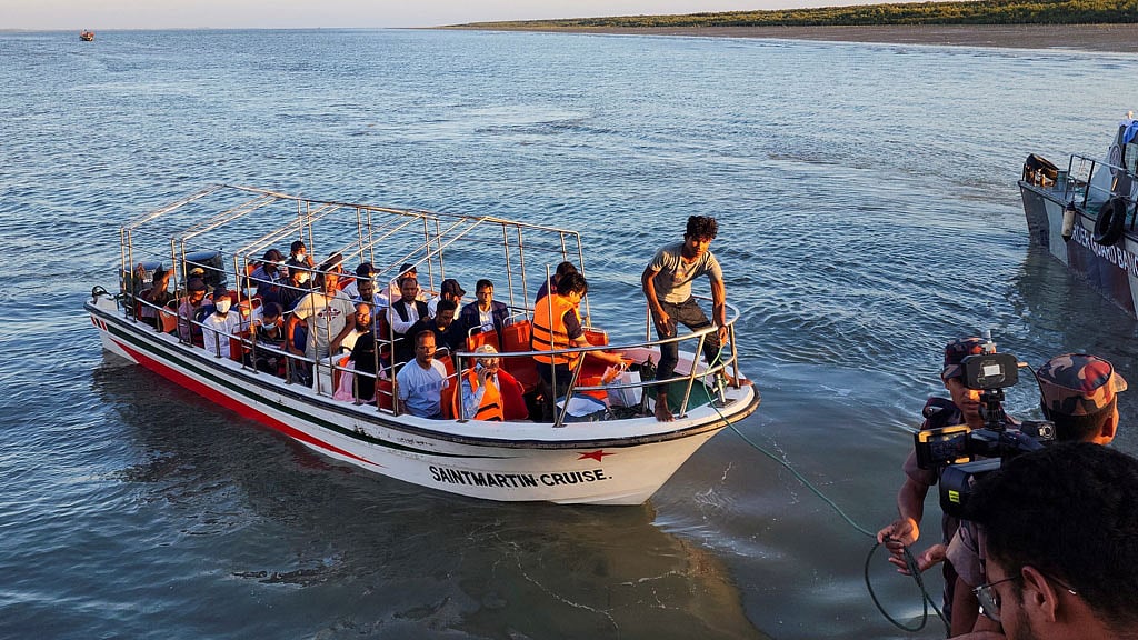 Some Rohingya Muslim refugees and Bangladeshi officials on a boat return after visiting Myanmar's Rakhine State as part of an effort to encourage their voluntary repatriation, in Teknaf, Cox's Bazar, Bangladesh, May 5, 2023. 