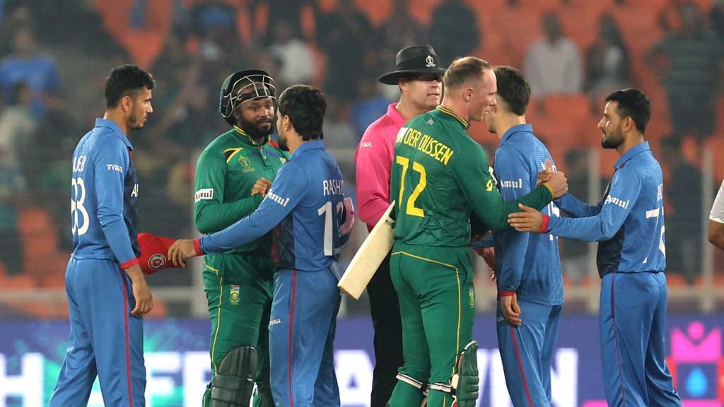 ICC Cricket World Cup 2023 - South Africa v Afghanistan - Narendra Modi Stadium, Ahmedabad, India - November 10, 2023 South Africa's Andile Phehlukwayo and Rassie van der Dussen shake hands with Afghanistan players after the match REUTERS/Amit Dave