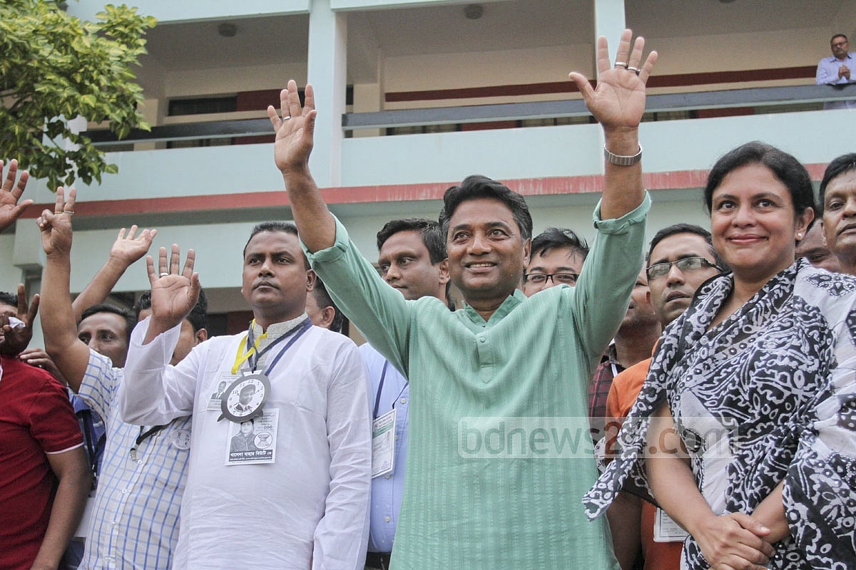He waves to crowds at the victory rally in Dhaka.