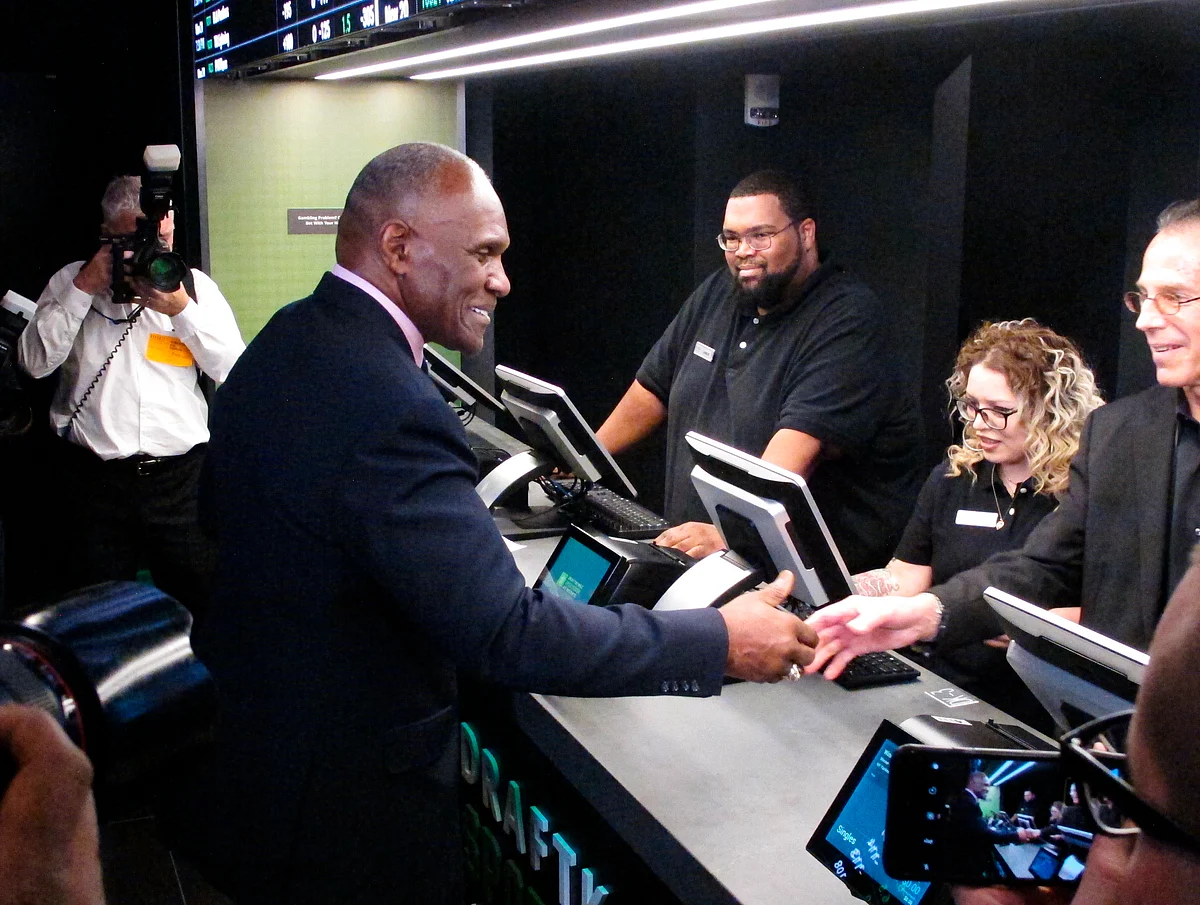 FILE - In this Nov. 20, 2018 file photo, former New York Giants linebacker Harry Carson places a bet on the New York Yankees to win the 2019 World Series at Resorts Casino in Atlantic City, N.J. The race to legalize sports betting is on now that the U.S. Supreme Court has allowed it in all 50 states, but will it provide enough extra tax revenue to make much of a difference for schools, roads or pension debt? (AP Photo/Wayne Parry)