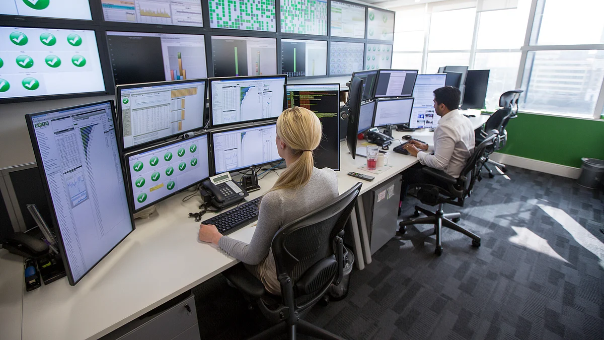 Exchange staff look at financial data on computer screens on the trading floor of Bats Europe. (Photographer: Jason Alden/Bloomberg)