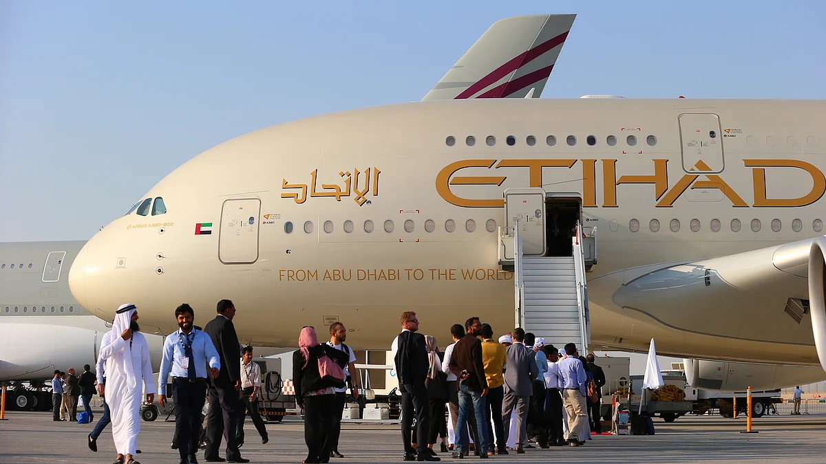 Visitor queue to access an Airbus A380-800 aircraft, operated by Etihad Airways, during 14th Dubai Air Show at Dubai World Central (DWC) in Dubai (Photographer: Jasper Juinen/Bloomberg)