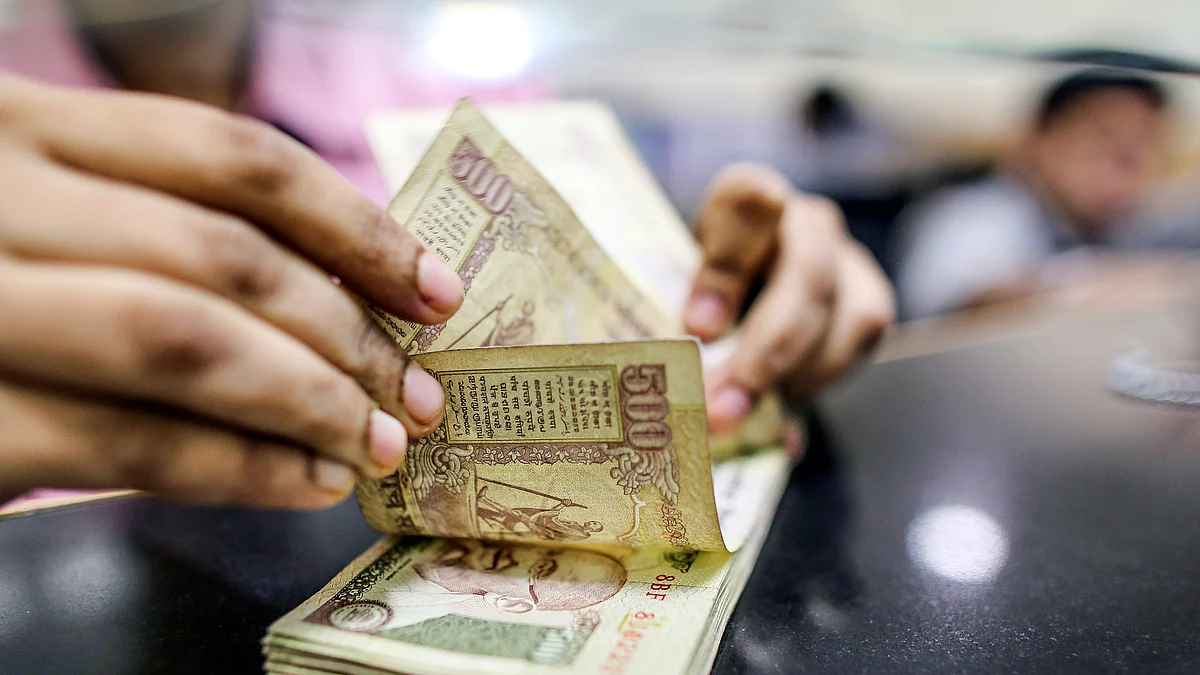 An employee counts Indian five-hundred rupee banknotes for a photograph at a branch of the HDFC Bank. (Photographer: Dhiraj Singh/Bloomberg)